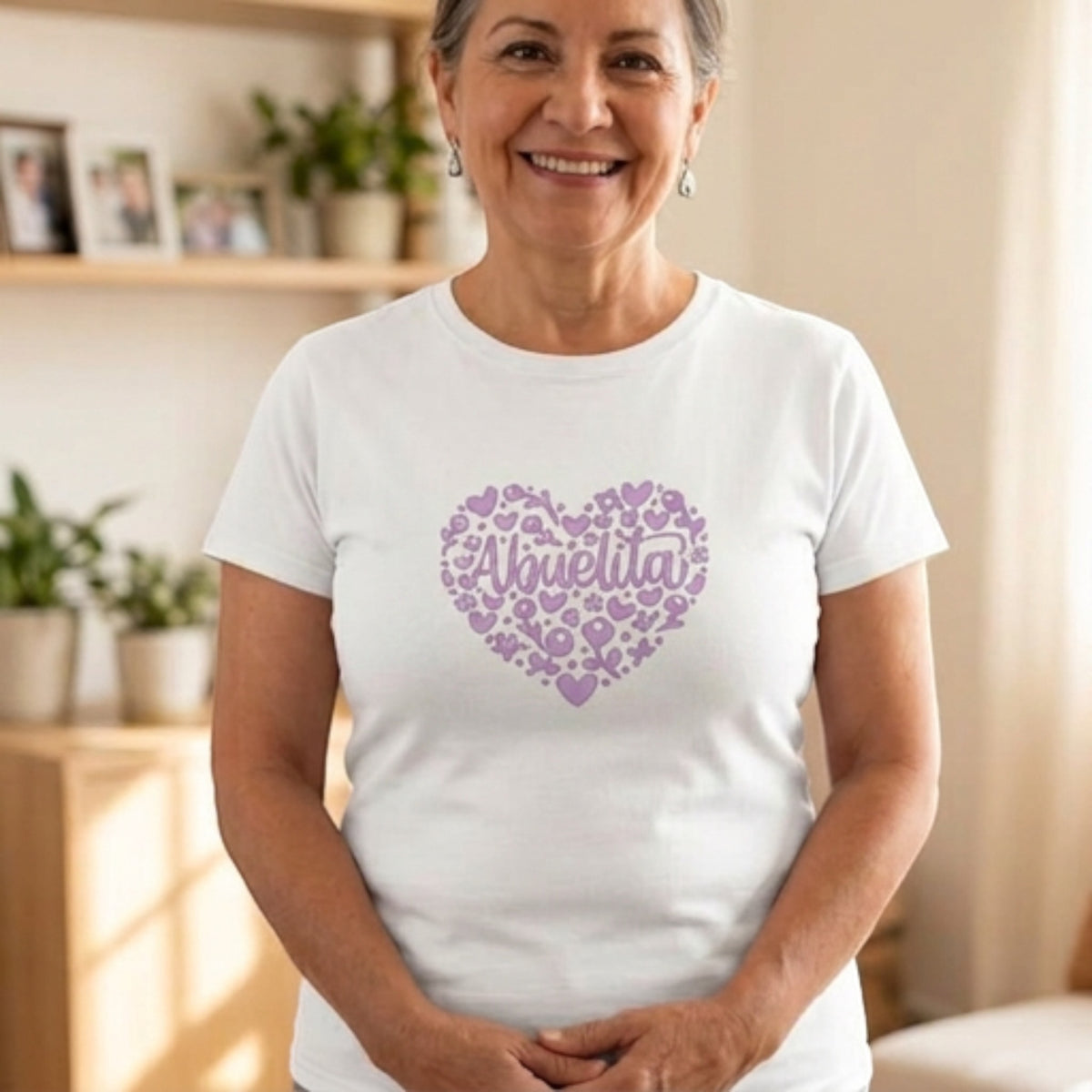 The Beauty Closet white cotton crewneck t-shirt featuring a purple heart-shaped floral graphic with Abuelita text.