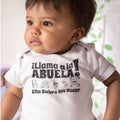 The Beauty Closet white baby bodysuit with black Spanish text and cute toy icons worn by a toddler