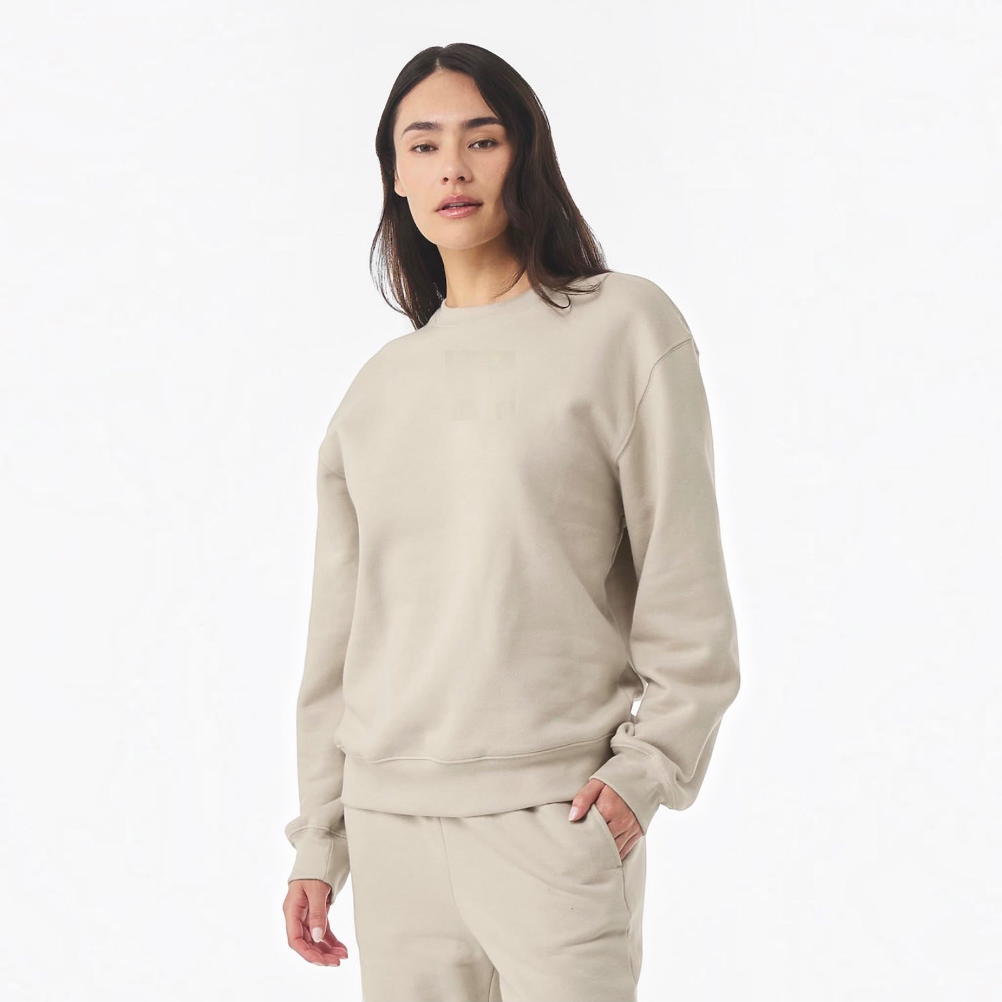 The Beauty Closet unisex beige fleece crewneck sweatshirt worn by a woman against a plain white background.