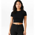 The Beauty Closet black cotton crewneck crop top worn by a woman with wavy hair against a white background