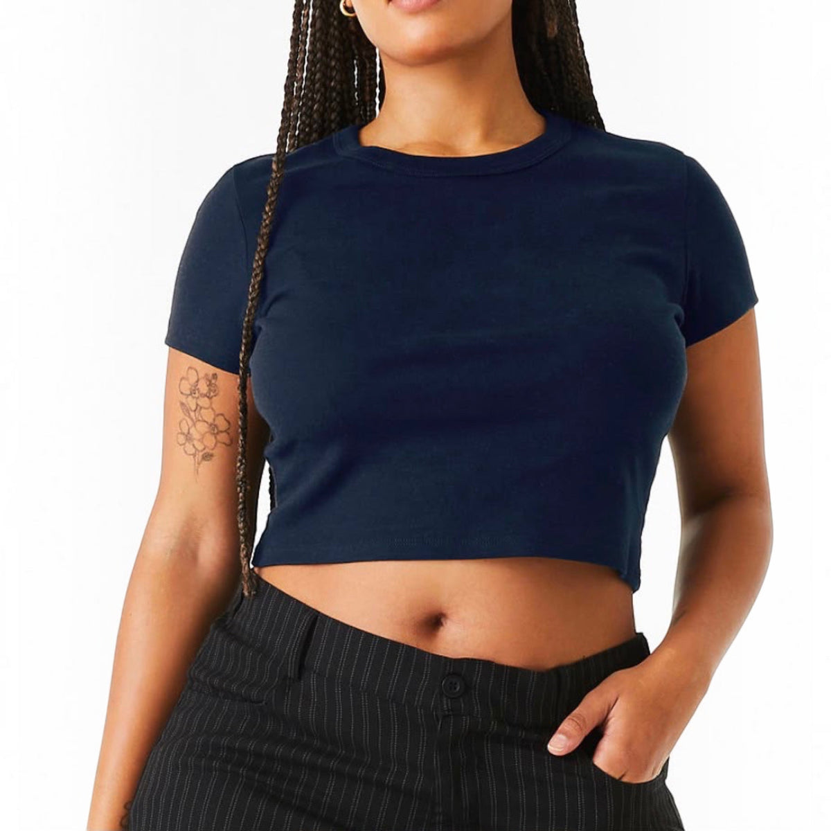The Beauty Closet black cotton crewneck crop top worn by a woman with braided hair