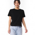 The Beauty Closet black cotton crewneck t-shirt worn by a woman with light wash denim jeans
