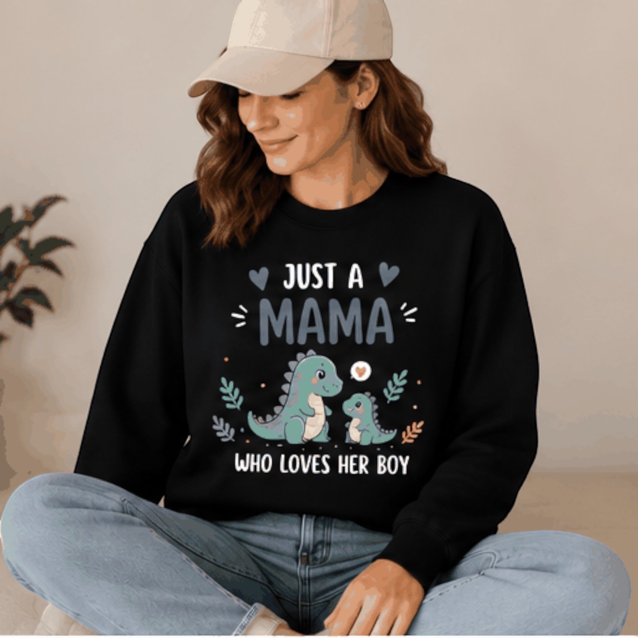 The Beauty Closet black crewneck sweatshirt featuring a cute dinosaur graphic with the text Just a Mama who loves her boy