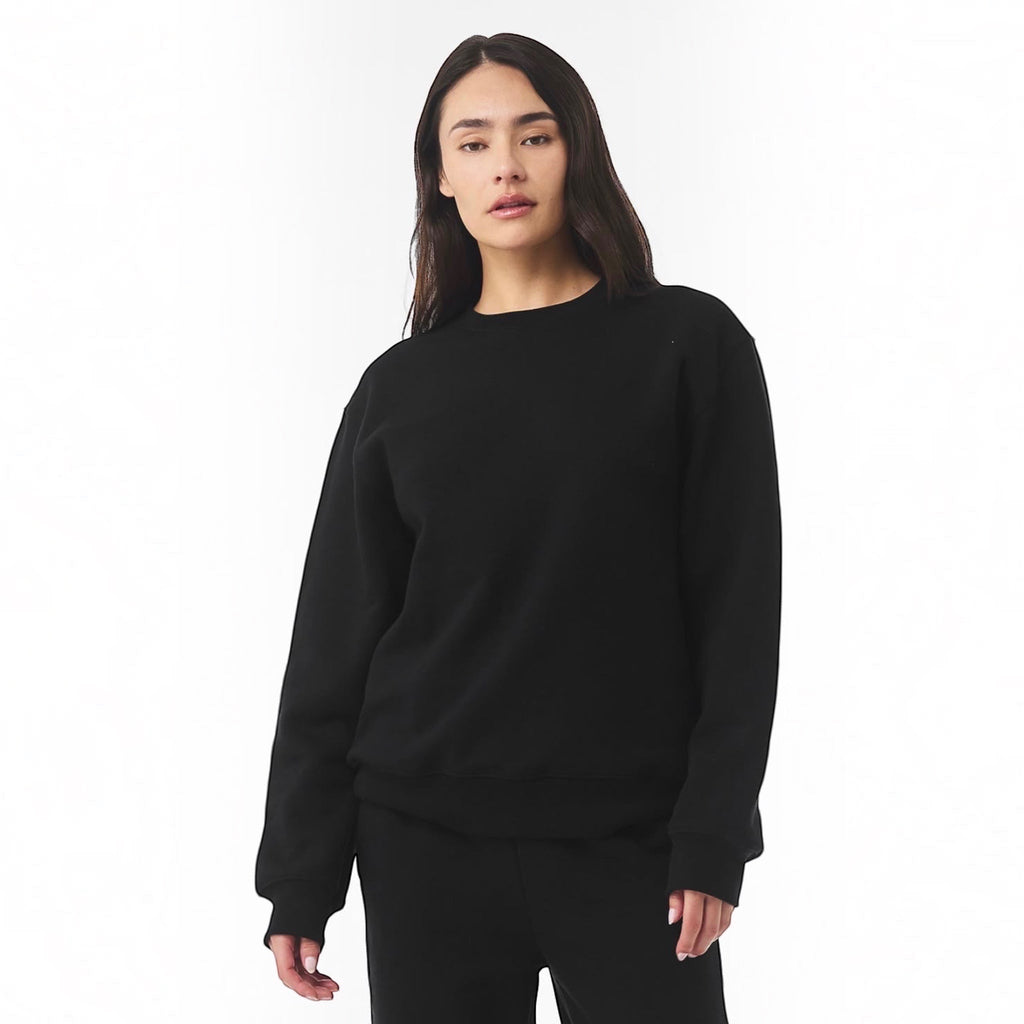 The Beauty Closet unisex black fleece crewneck sweatshirt worn by a woman against a white background.
