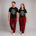 The Beauty Closet black cotton t-shirt with white Spanish text graphic, paired with red and black plaid pants.
