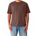 The Beauty Closet brown short sleeve crewneck t-shirt in a relaxed fit worn with blue denim jeans
