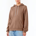 The Beauty Closet brown pullover hoodie with a drawstring hood and kangaroo pocket worn by a model with blue jeans.
