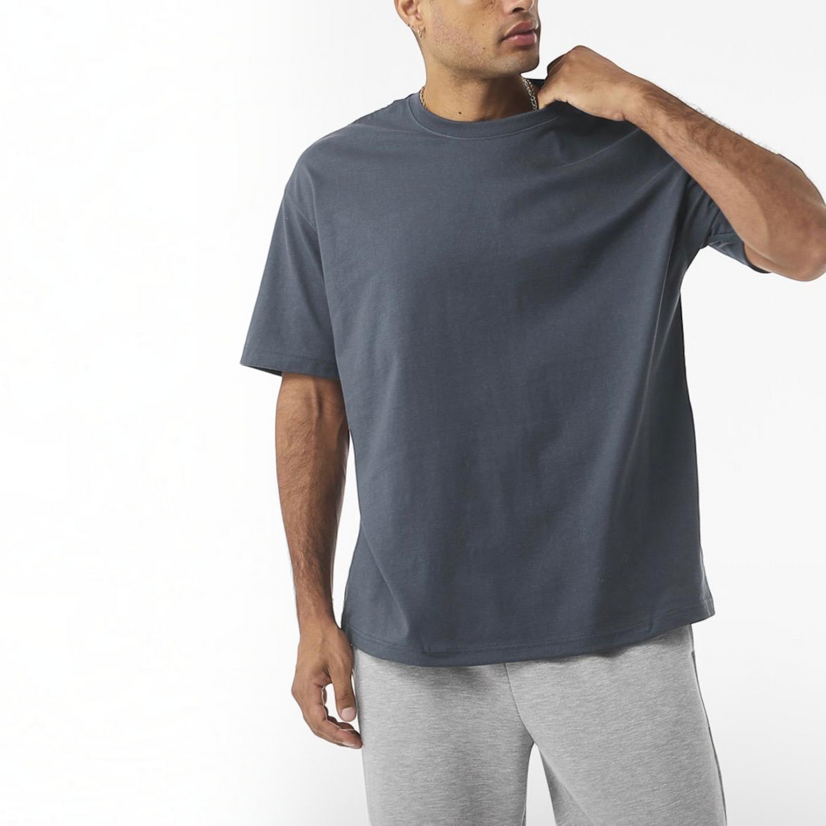 The Beauty Closet crew neck t-shirt in charcoal grey cotton worn by a man against a white background.