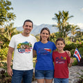 The Beauty Closet family wearing matching Costa Rica themed graphic t-shirts in a tropical outdoor setting.