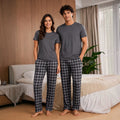 The Beauty Closet matching couple's grey t-shirt and black & grey plaid pajama pants set.