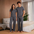 The Beauty Closet matching couple's grey t-shirt and black & grey plaid pajama pants set.