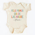 The Beauty Closet cream baby bodysuit with colorful Feliz Primer Dia De Las Madre Mama text graphic