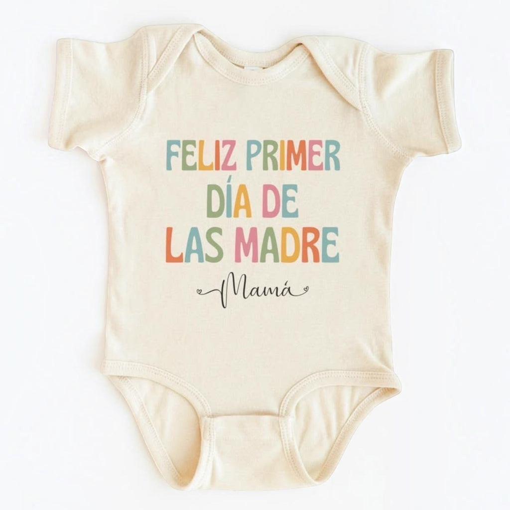 The Beauty Closet cream-colored baby bodysuit featuring colorful Feliz Primer Dia De Las Madre Mama graphic print