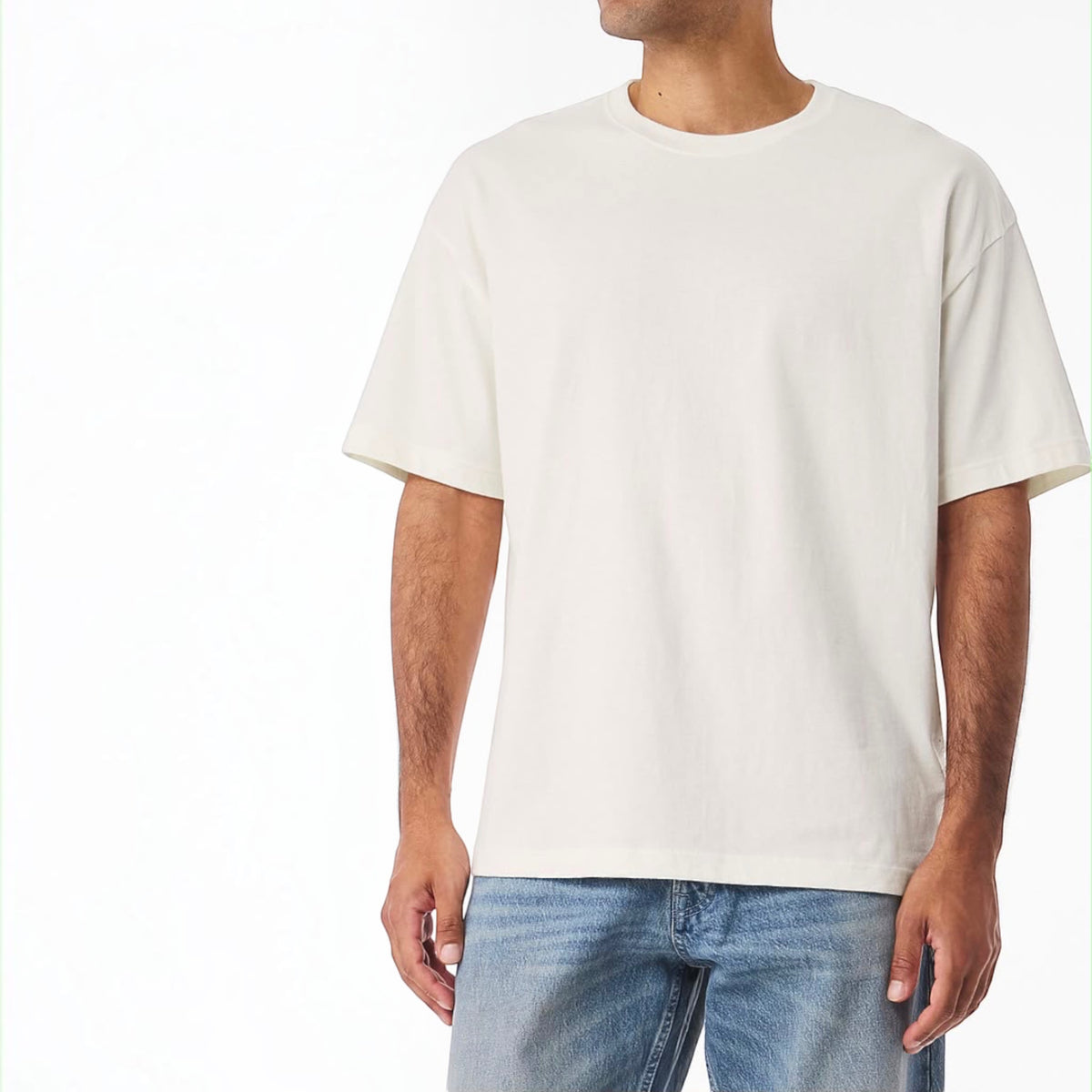 The Beauty Closet cream cotton crewneck t-shirt worn by a man with blue denim jeans