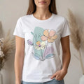 The Beauty Closet cream cotton t-shirt featuring a delicate floral line art graphic with soft pastel accents