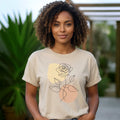 The Beauty Closet cream cotton t-shirt with a minimalist black line art rose graphic and soft pastel accents.