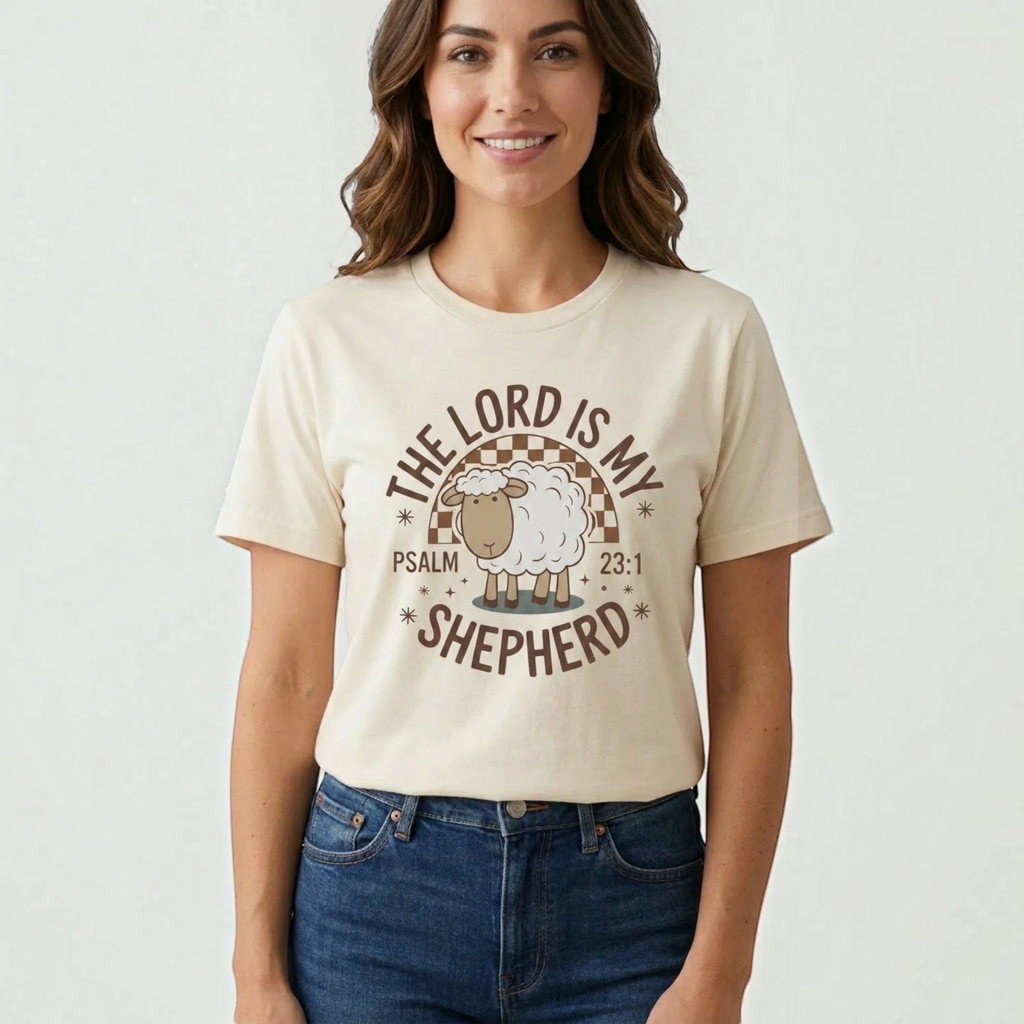 Woman wearing a cream The Beauty Closet t-shirt with a brown graphic of a sheep and The Lord Is My Shepherd text