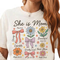 The Beauty Closet white cotton t-shirt featuring colorful floral and ribbon illustrations with inspirational Bible verses.