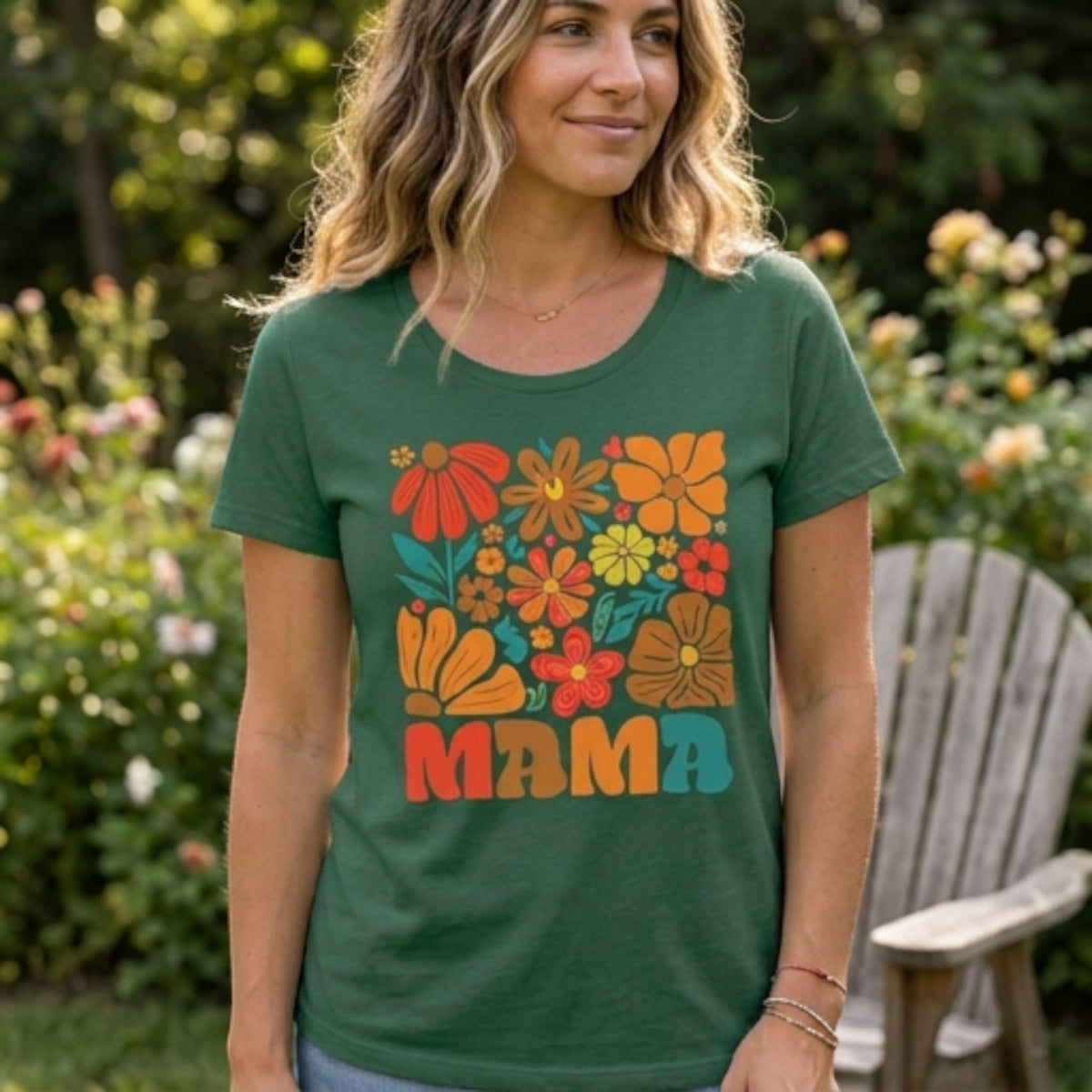 The Beauty Closet green cotton t-shirt featuring a colorful retro floral Mama graphic print worn by a woman outdoors.
