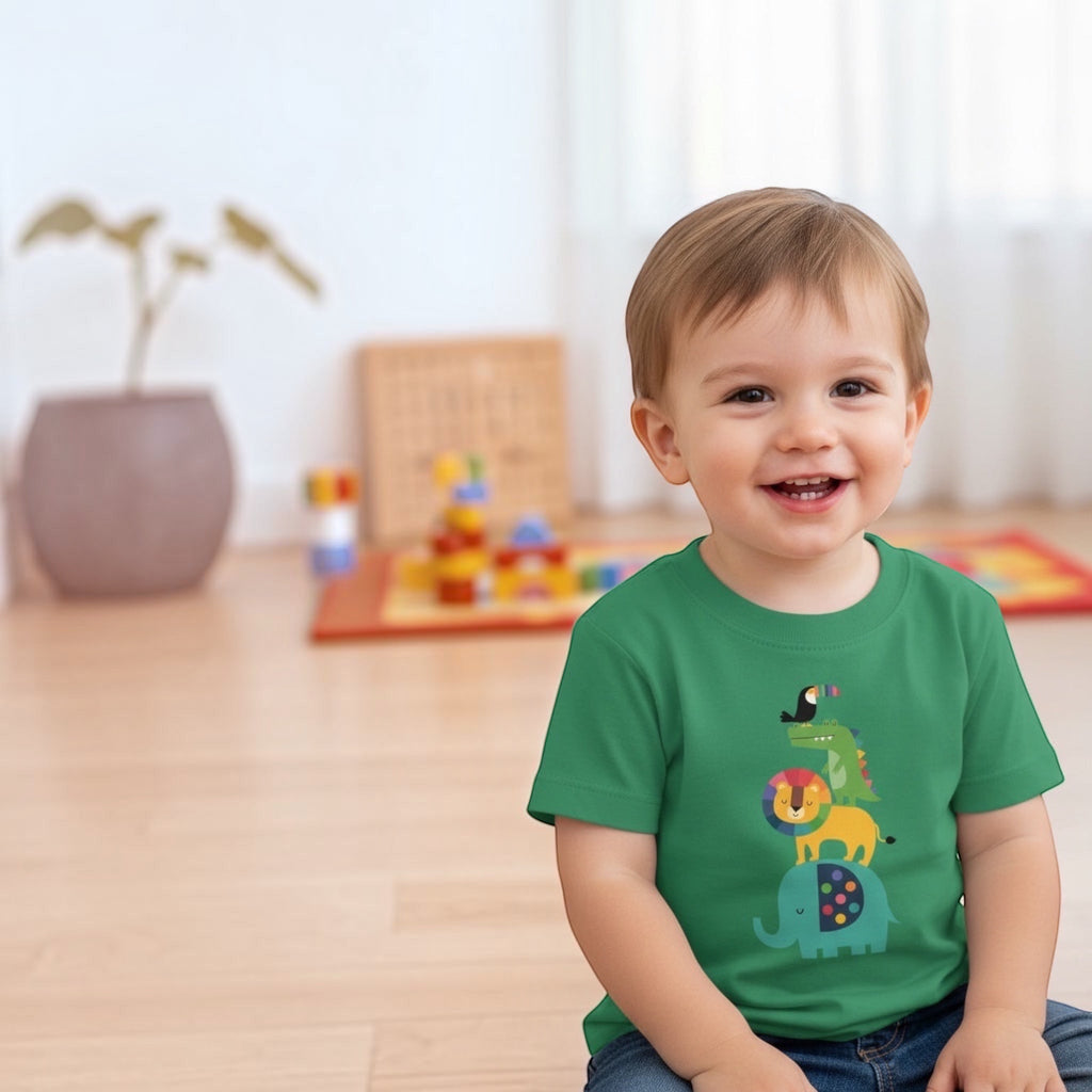 Toddler wearing a green The Beauty Closet t-shirt with a colorful animal stack print of an elephant, lion, and toucan
