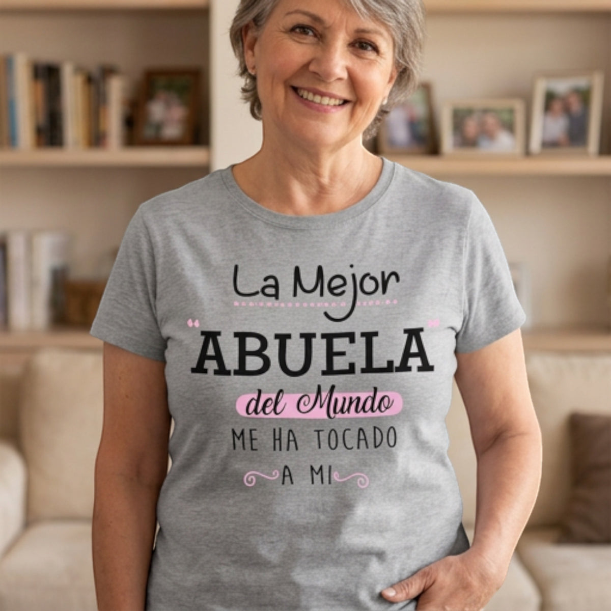 The Beauty Closet grey cotton t-shirt with La Mejor Abuela graphic print worn by a smiling woman in a home setting