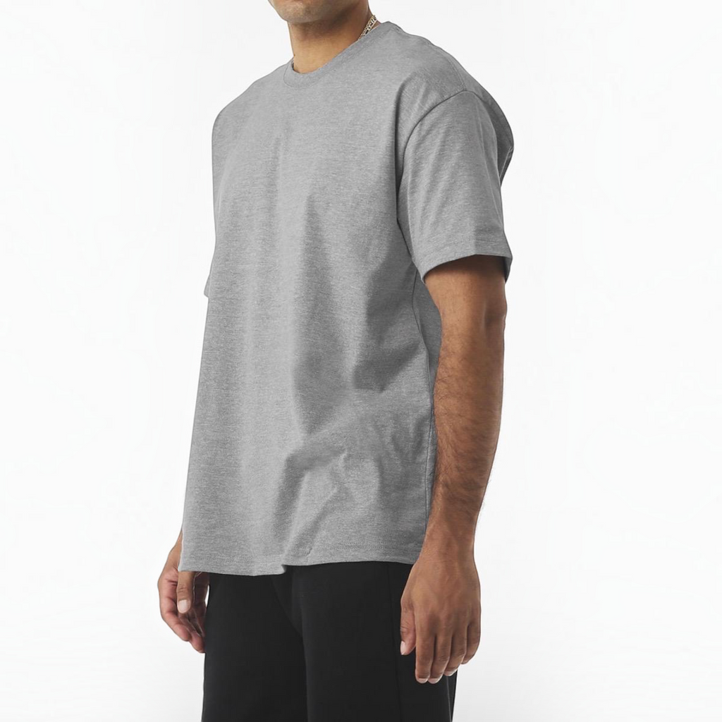 A man wearing a grey crew neck short sleeve cotton t-shirt from The Beauty Closet, featuring a relaxed classic fit.