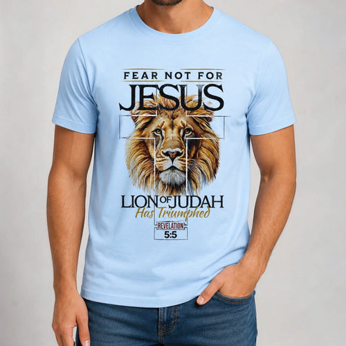 Light blue cotton t-shirt with a graphic of a lion's head superimposed on a cross, with text "FEAR NOT FOR JESUS LION OF JUDAH Has Triumphed REVELATION 5:5".