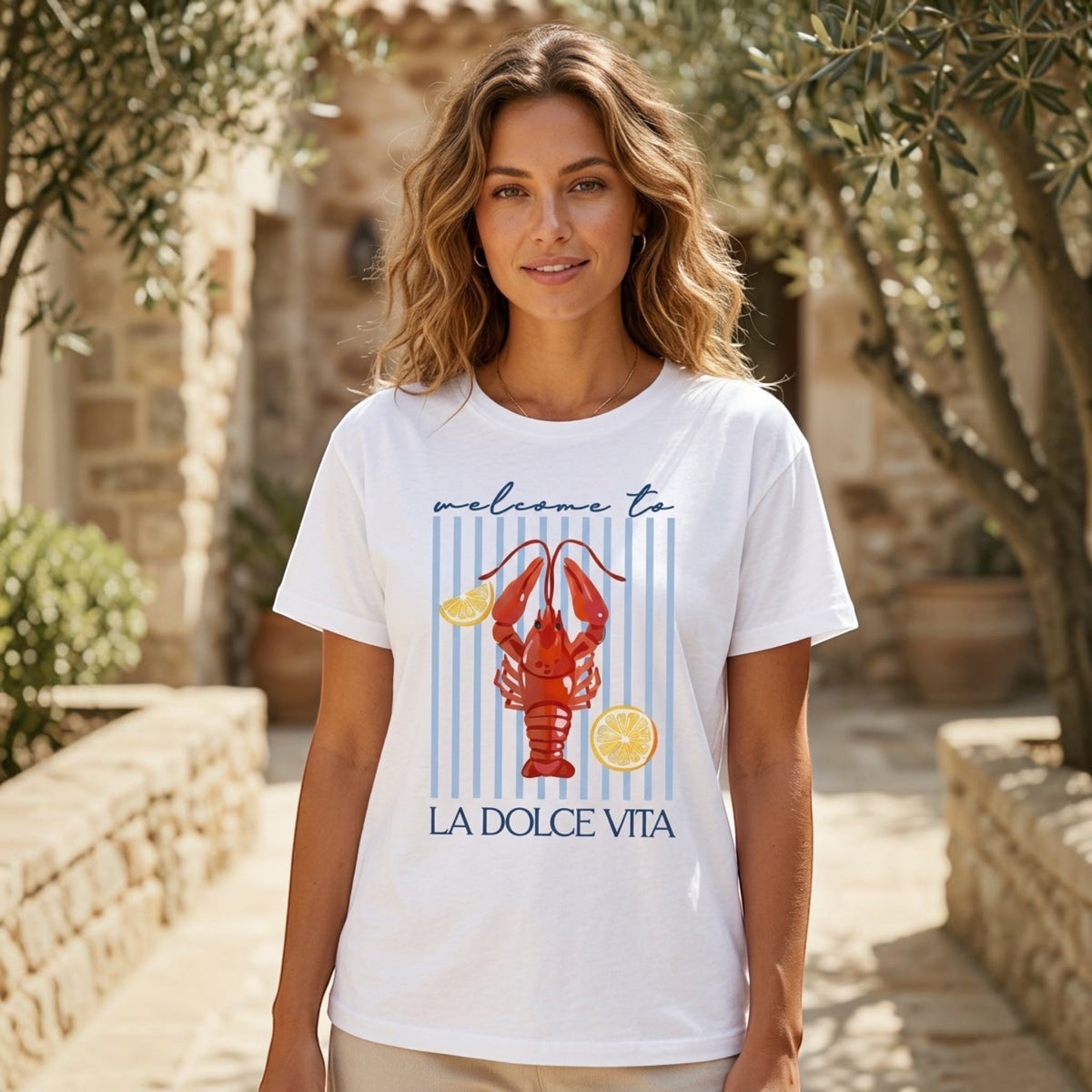The Beauty Closet white cotton crewneck t-shirt with a lobster and lemon graphic print on blue vertical stripes.