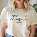 The Beauty Closet cream crewneck t-shirt with Mama Est 2024 script and colorful minimalist hearts graphic