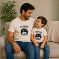 The Beauty Closet matching father and son cream t-shirts with gamer controller graphics for a fun family pajama set.