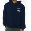 The Beauty Closet navy blue unisex fleece hoodie with a white Colegio 1985 crest graphic on the chest.