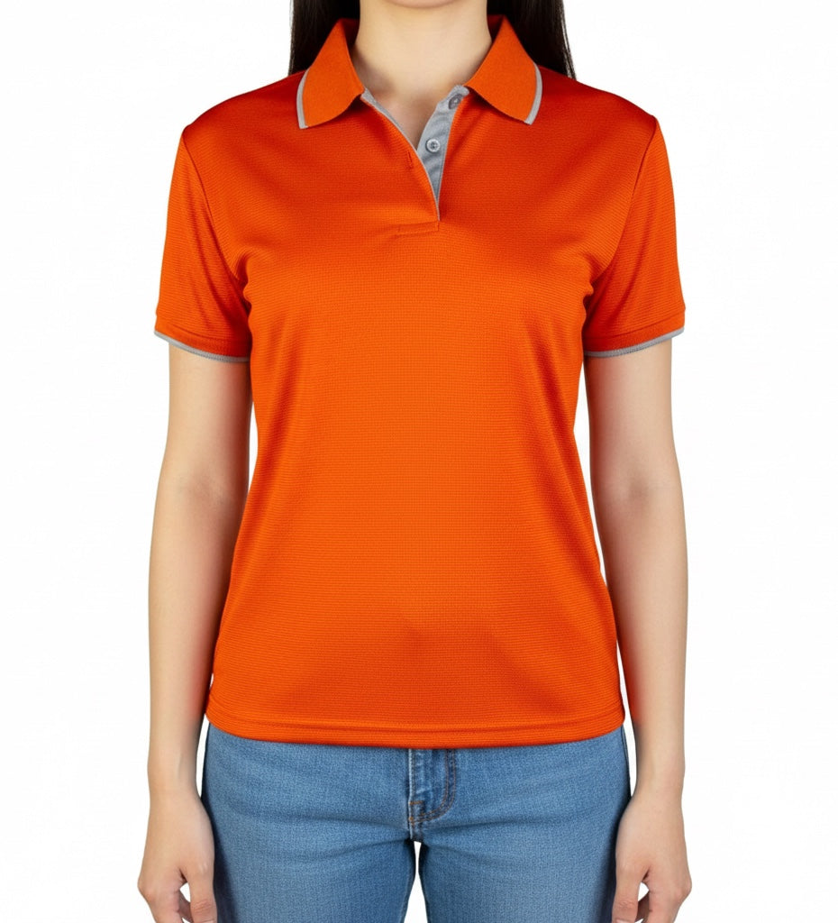 The Beauty Closet orange short sleeve polo shirt with grey collar trim worn by a woman with blue denim jeans