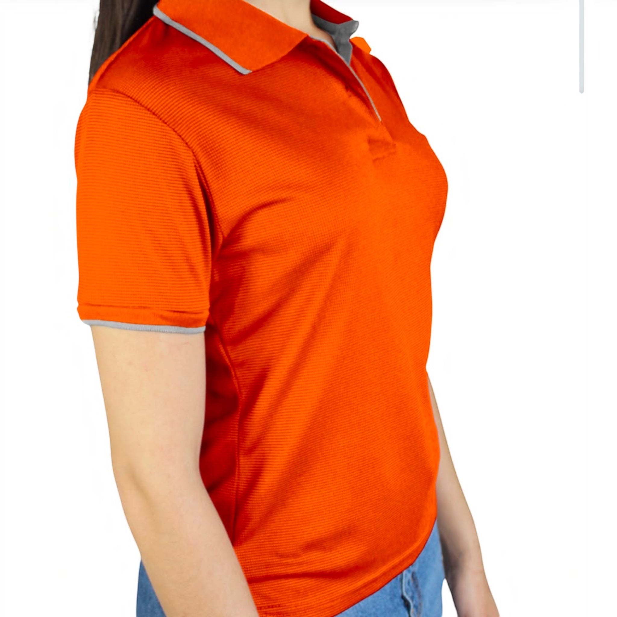 The Beauty Closet orange short sleeve polo shirt with grey collar and cuff trim worn by a woman