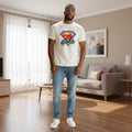 The Beauty Closet off-white crew neck t-shirt with a Papa superhero shield graphic worn by a man in a living room.