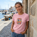The Beauty Closet pink cotton crewneck t-shirt featuring a sardine tin graphic print worn by a woman outdoors.