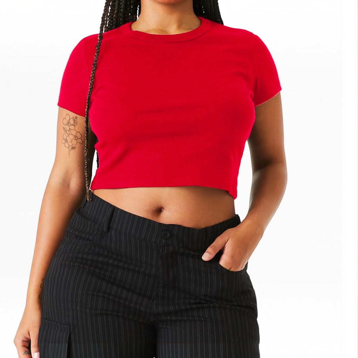 The Beauty Closet red cotton cropped crewneck t-shirt worn by a woman with braided hair and pinstriped trousers