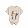 The Beauty Closet cream cotton t-shirt featuring a Super Mom graphic illustration of a mother and daughter.