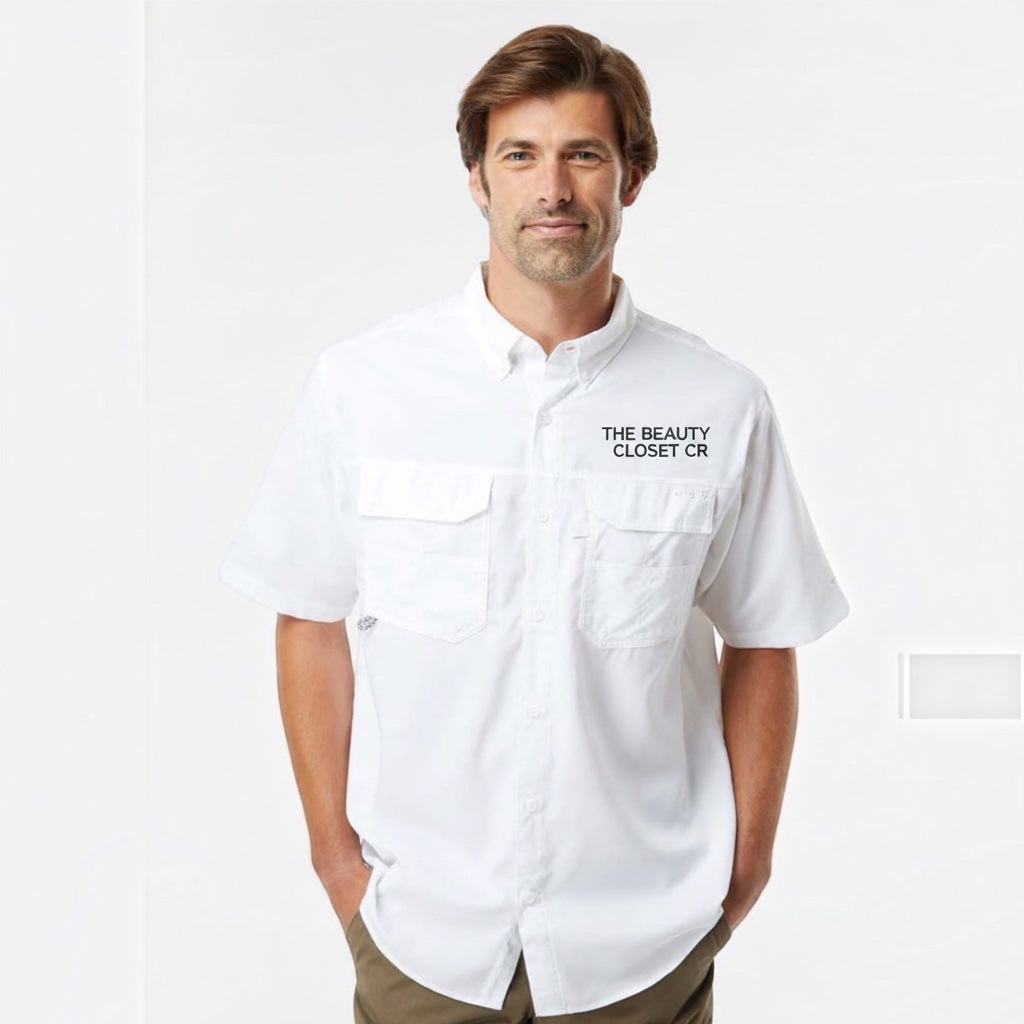 Man wearing a white short-sleeved button-down shirt from The Beauty Closet with two chest pockets