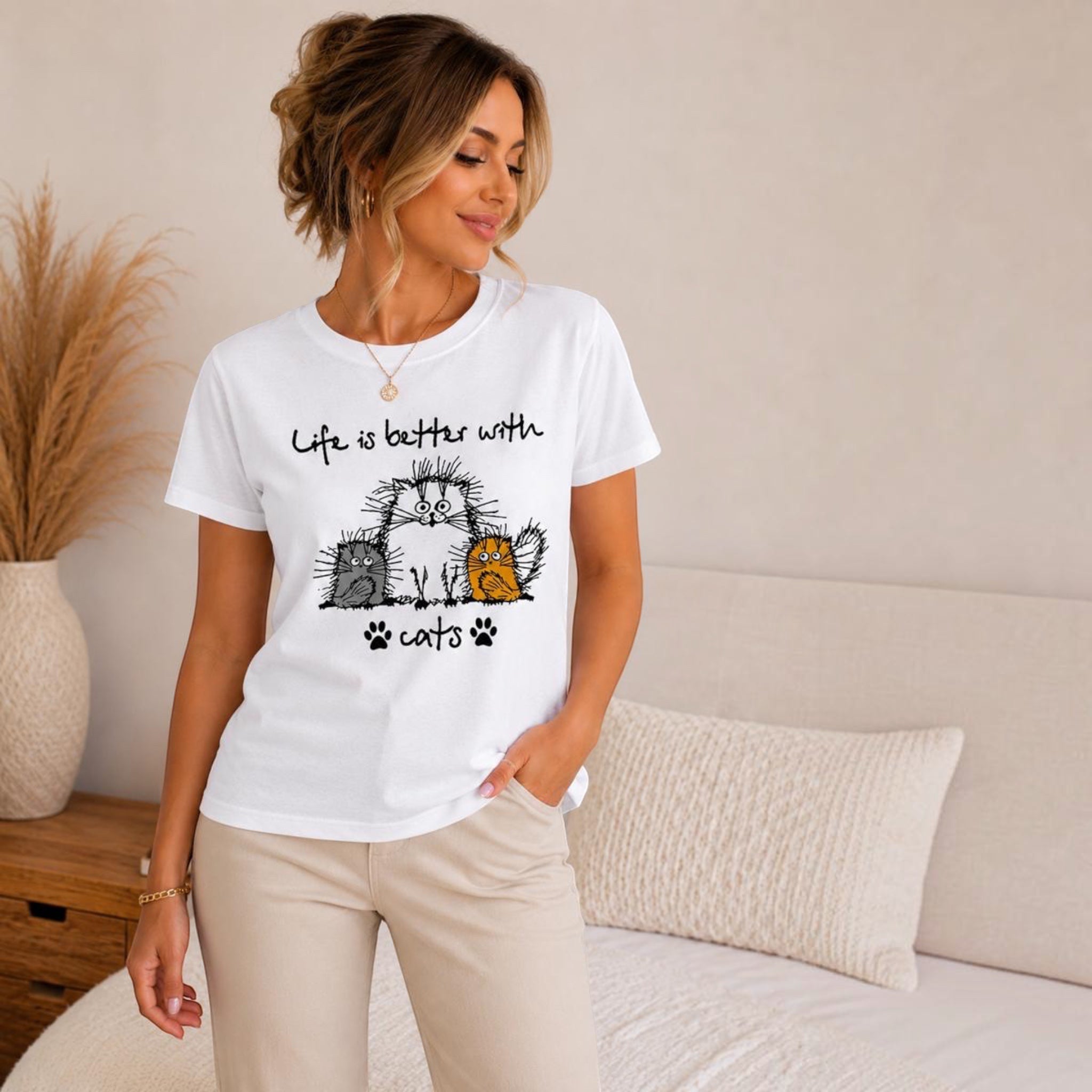 The Beauty Closet white short sleeve t-shirt with a Life is better with cats graphic print worn by a woman.