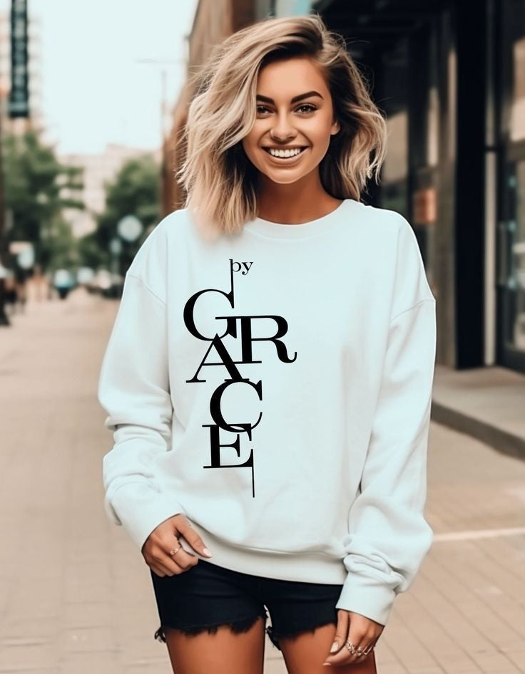 The Beauty Closet white sweatshirt featuring a vertical black Grace typography design worn by a smiling woman.