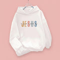 The Beauty Closet white oversized hoodie featuring a colorful Jesus graphic with minimalist typography on a pink background