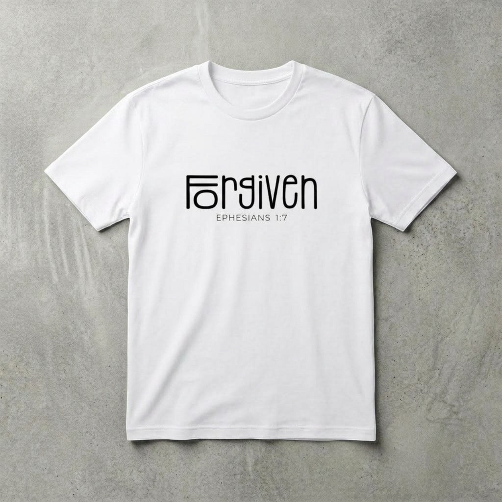 The Beauty Closet white cotton t-shirt with black Forgiven Ephesians 1:7 graphic print on a grey textured background.