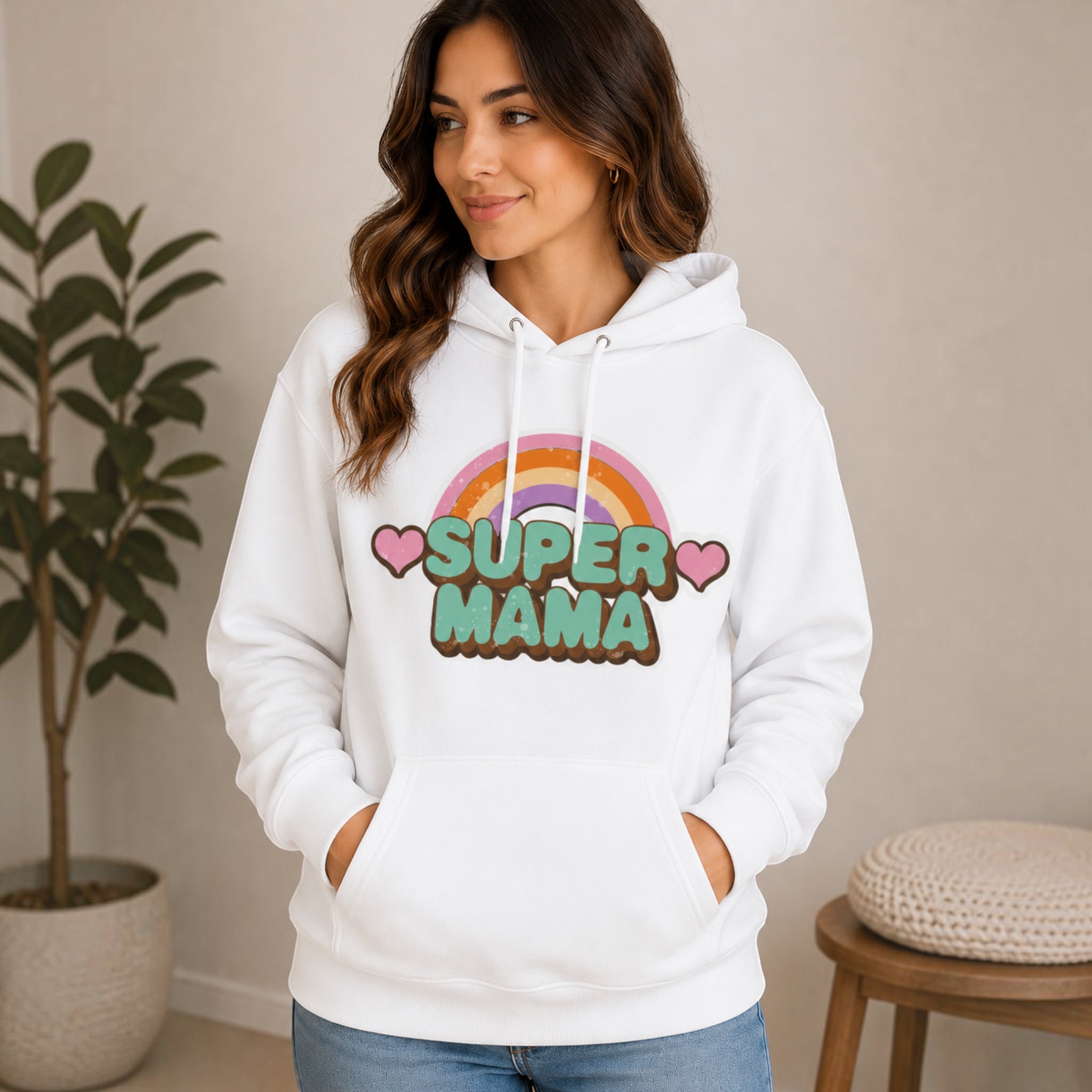 The Beauty Closet white hoodie featuring a Super Mama graphic with a rainbow and hearts worn by a smiling woman.