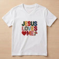 The Beauty Closet white v-neck t-shirt featuring colorful embroidered Jesus Loves Me text and a heart patch.